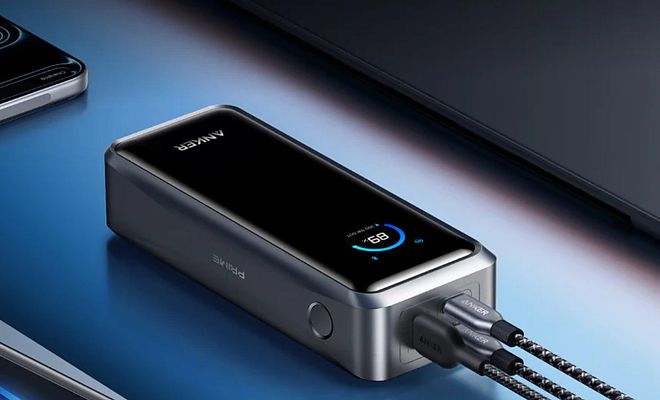 Batería externa Anker Prime con pantalla digital y dos cables USB-C conectados para cargar varios dispositivos
