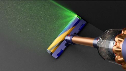 Cepillo de la aspiradora Dyson iluminando el polvo y la suciedad del suelo con luz verde.