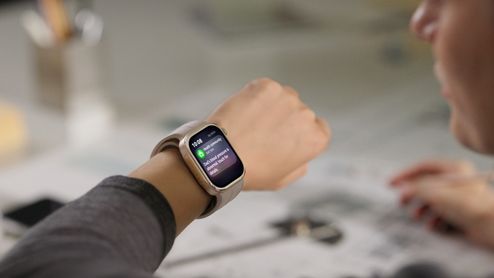 Huawei Watch D3 con correa beige en la muñeca de una persona, mostrando una notificación.