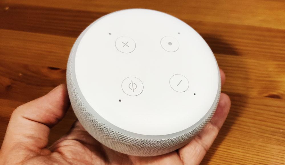 Amazon Echo Dot speaker in hand